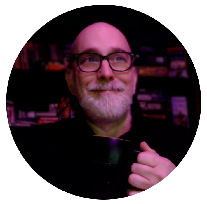 Kevin holding a coffee and smiling